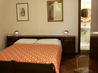 Letto o letti in una camera di Albergo Corona