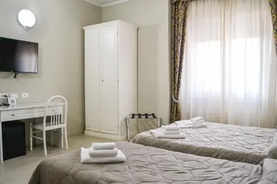 Letto o letti in una camera di Hotel Domus