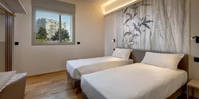 Letto o letti in una camera di Park Hotel & Residence by The Cube