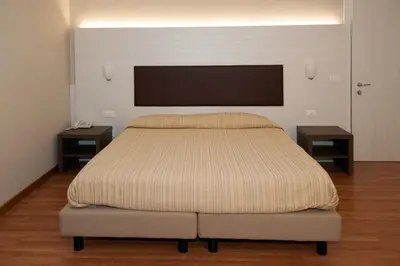 Letto o letti in una camera di HOTEL BUCA DI BACCO