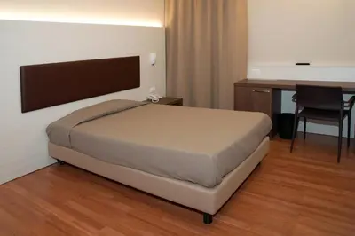Letto o letti in una camera di HOTEL BUCA DI BACCO