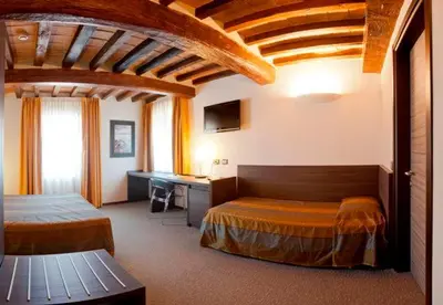 Letto o letti in una camera di Locanda Sant'Ambrogio