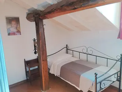 Letto o letti in una camera di DELIZIOSO ATTICO CON AMPIO TERRAZZO e GARAGE A DUE PASSI DAL MARE e DALLE CINQUETERRE LT-0485