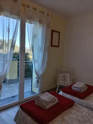 Letto o letti in una camera di Appartamento Taggiasca con piscina - Riva Trigoso