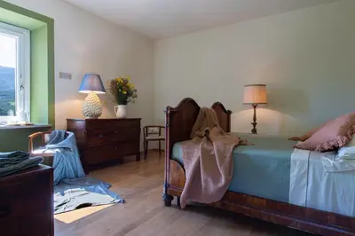 Letto o letti in una camera di Relais SANT'AMBROGIO