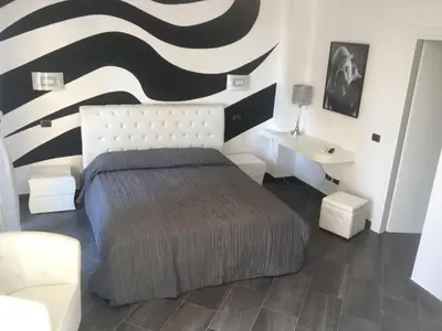 Letto o letti in una camera di Le Divine di via Olivieri - Reception Via XXV Aprile 5