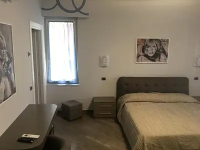 Letto o letti in una camera di Le Divine di via Olivieri - Reception Via XXV Aprile 5