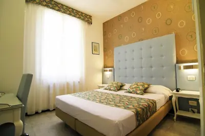 Letto o letti in una camera di Hotel Souvenir