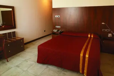 Letto o letti in una camera di La Corte Albergo Meublé