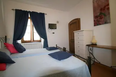 Letto o letti in una camera di B&B Castello Malaspina di Tresana