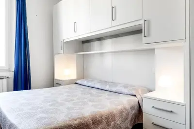 Letto o letti in una camera di GuestHost - Migliarina Cozy Apartment