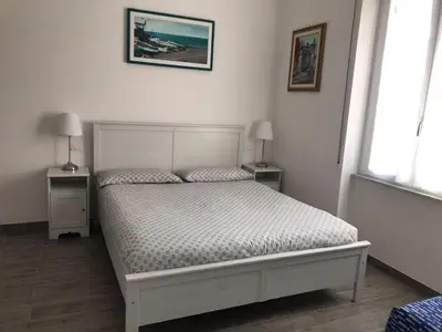 Letto o letti in una camera di HOST IN LEVANTO - Maestrale con biciclette