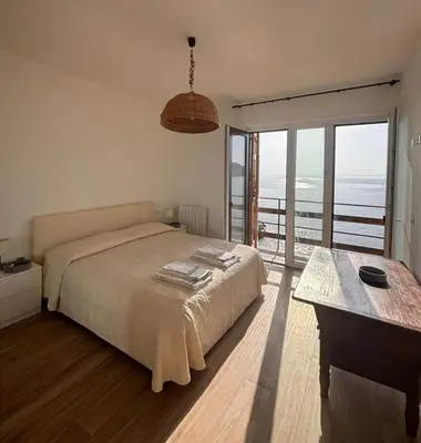 Letto o letti in una camera di M'illumino d'immenso - MONEGLIA APARTMENTS