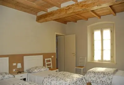 Letto o letti in una camera di Ostello La Canonica