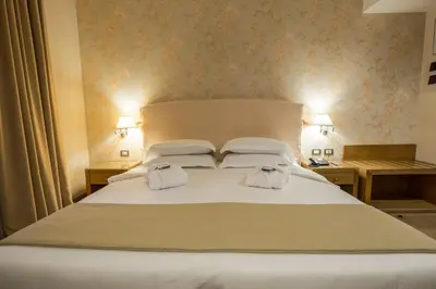 Letto o letti in una camera di Hotel Touring