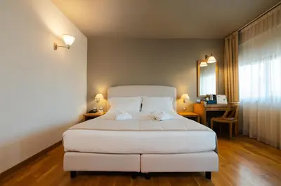 Letto o letti in una camera di Hotel Touring