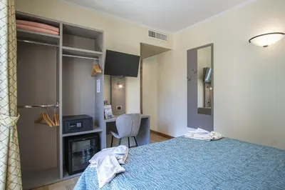 Letto o letti in una camera di Grande Albergo