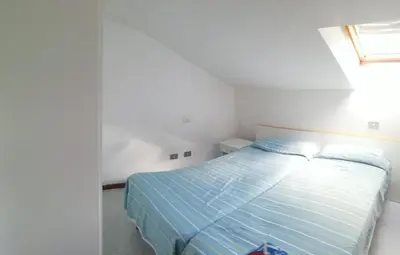 Letto o letti in una camera di Attico del sole zero undici zero uno sette lt 0787