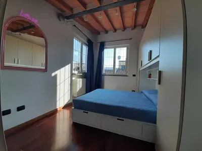 Letto o letti in una camera di Appartamento sui tetti di Parma