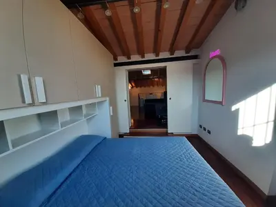 Letto o letti in una camera di Appartamento sui tetti di Parma