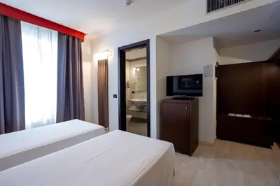 Letto o letti in una camera di Stadio Hotel