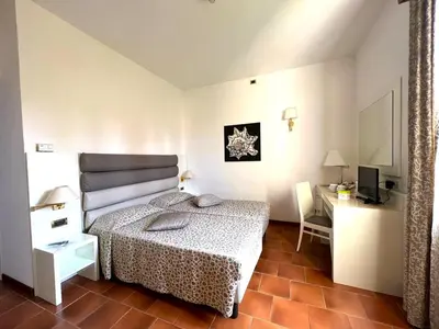 Letto o letti in una camera di Hotel Clelia