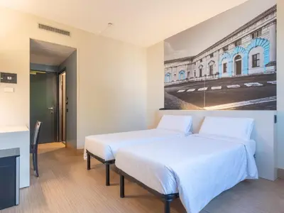 Letto o letti in una camera di B&B HOTEL Mantova