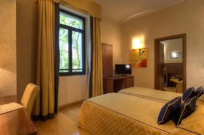 Letto o letti in una camera di Central Park Hotel Modena