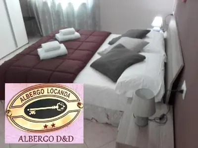 Letto o letti in una camera di ALBERGO ELENA 3 via emilia ovest 347