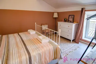 Letto o letti in una camera di Corte 1 con parcheggio gratuito