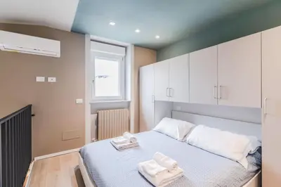 Letto o letti in una camera di Pavia Tower - by Host4U