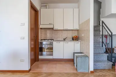 Cucina o angolo cottura di GuestHost - Parma Parco Ducale Duplex Apartment with parking