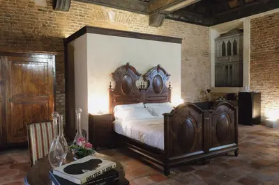Letto o letti in una camera di Foresteria Palazzo Guazzoni Zaccaria