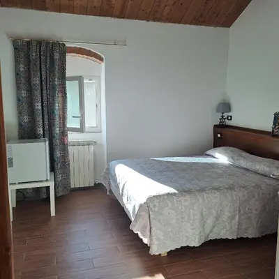Letto o letti in una camera di B&B La Casina Rosa La Spezia