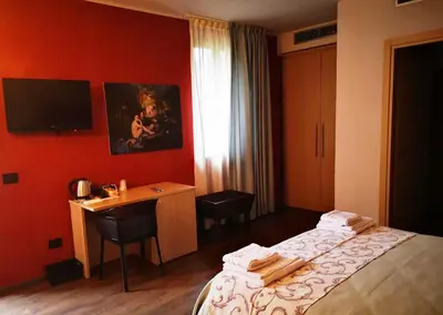 Letto o letti in una camera di ALBERGO BALDAZZI 1916